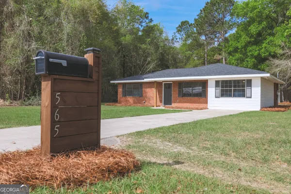 a view of a house with a backyard
