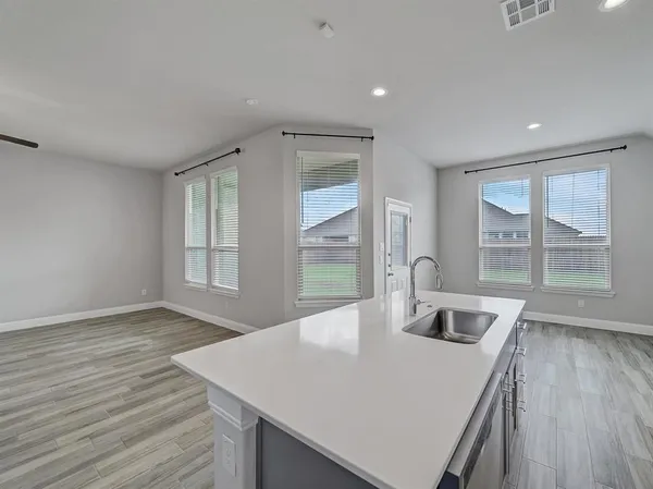 a bathroom with a sink a large mirror and a bathtub