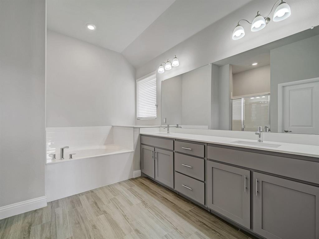 3443 April Breeze Trail Grand Prairie, TX 76065 - Photo 14 of 29 a spacious bathroom with a double vanity sink a mirror and a bathtub