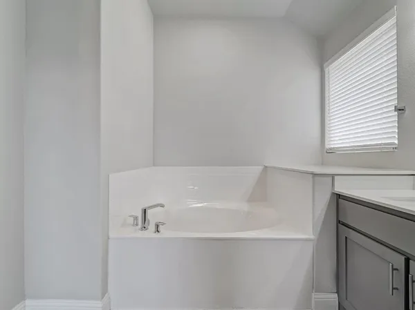 a spacious bathroom with a double vanity sink a mirror and a bathtub