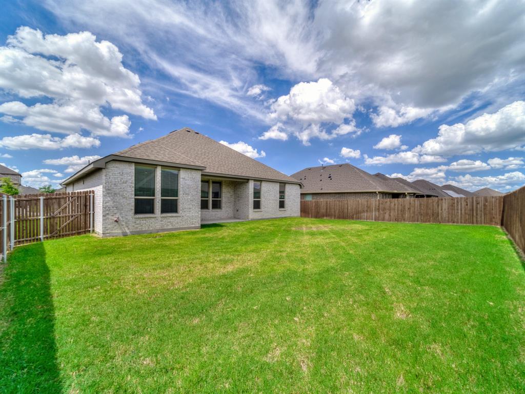 3443 April Breeze Trail Grand Prairie, TX 76065 - Photo 26 of 29 a front view of a house with a garden
