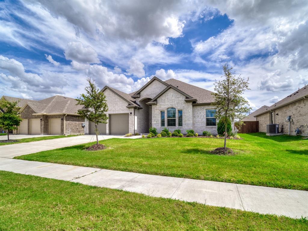 3443 April Breeze Trail Grand Prairie, TX 76065 - Photo 3 of 29 a front view of a house with a yard