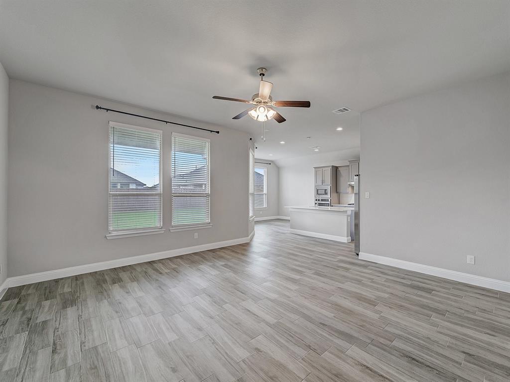 3443 April Breeze Trail Grand Prairie, TX 76065 - Photo 29 of 29 wooden floor in an empty room with a window