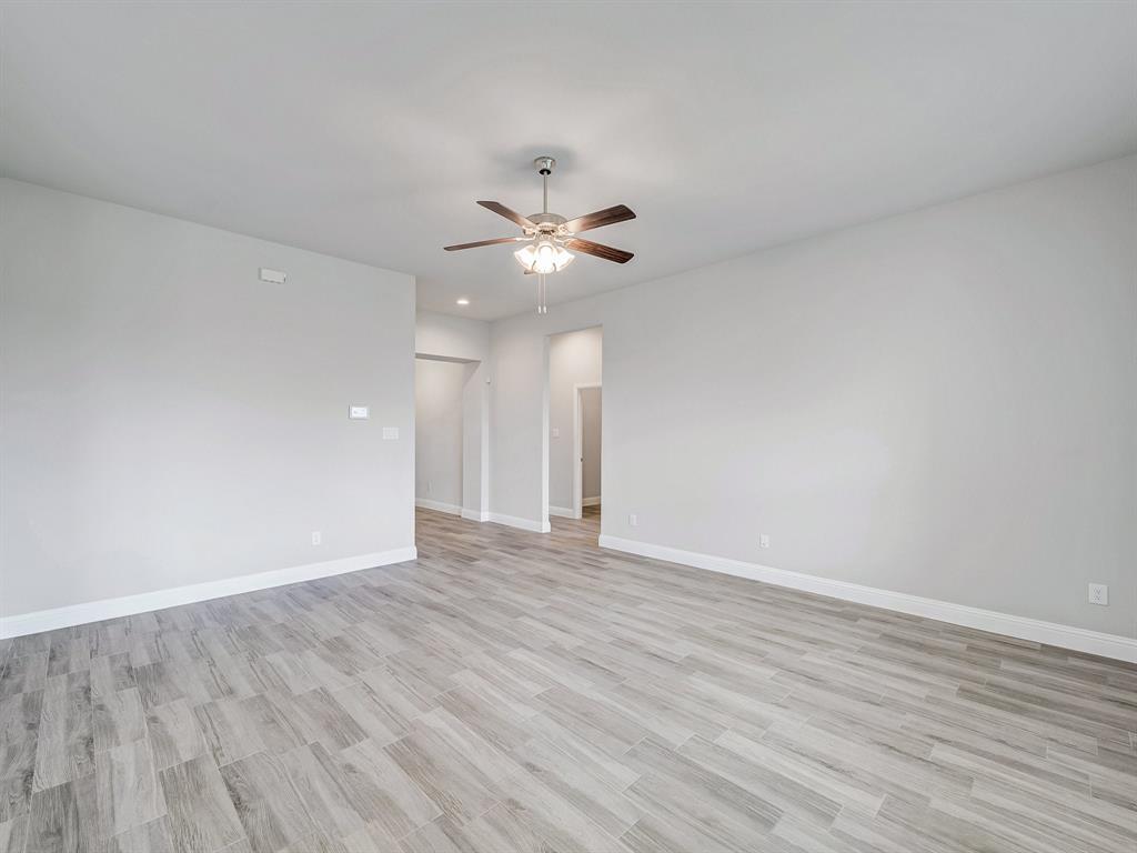 3443 April Breeze Trail Grand Prairie, TX 76065 - Photo 5 of 29 a view of an empty room with wooden floor