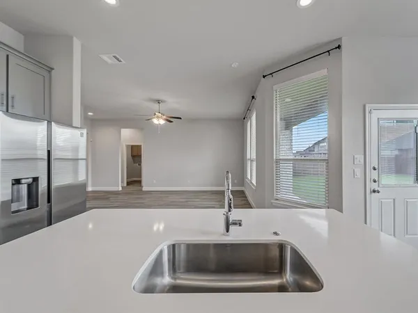 a kitchen with a sink a stove and refrigerator