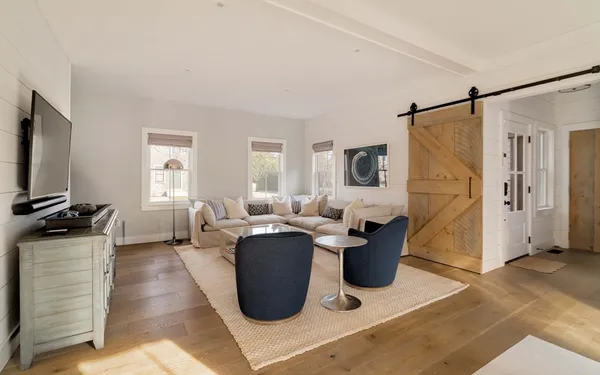 a living room with lots of furniture and a flat screen tv