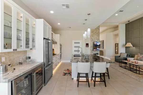 a large kitchen with a table and chairs