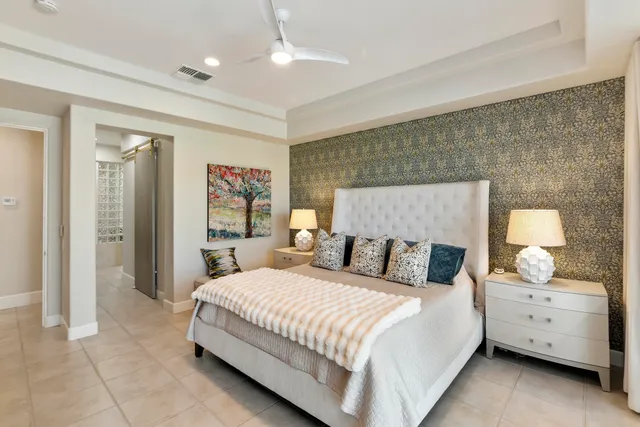 a bedroom with a bed and a night stand