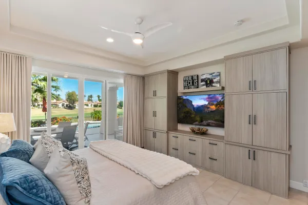 a bedroom with a bed and a flat screen tv