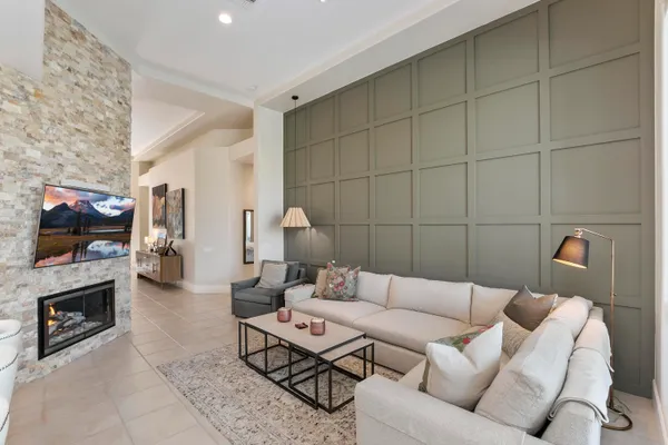 a living room with furniture a flat screen tv and a fireplace