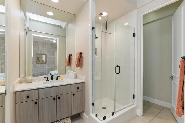 a bathroom with a shower sink and mirror