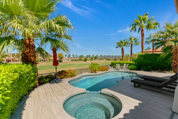 a view of a swimming pool and lounge chair