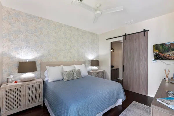 a bedroom with a bed and a tv