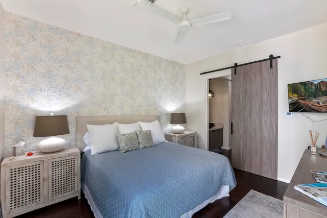 a bedroom with a bed and a tv