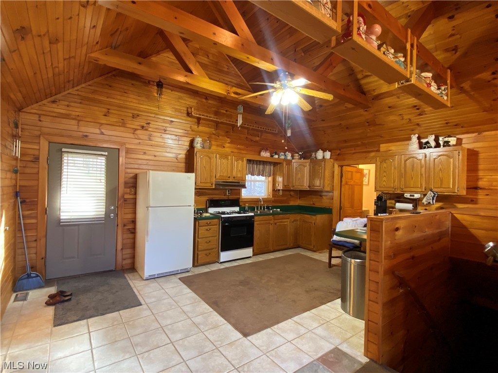 2008 Goose Creek Road Petroleum, WV 26161 - Photo 11 of 35 Kitchen with white appliances, ceiling fan, beamed ceiling, and light tile floors