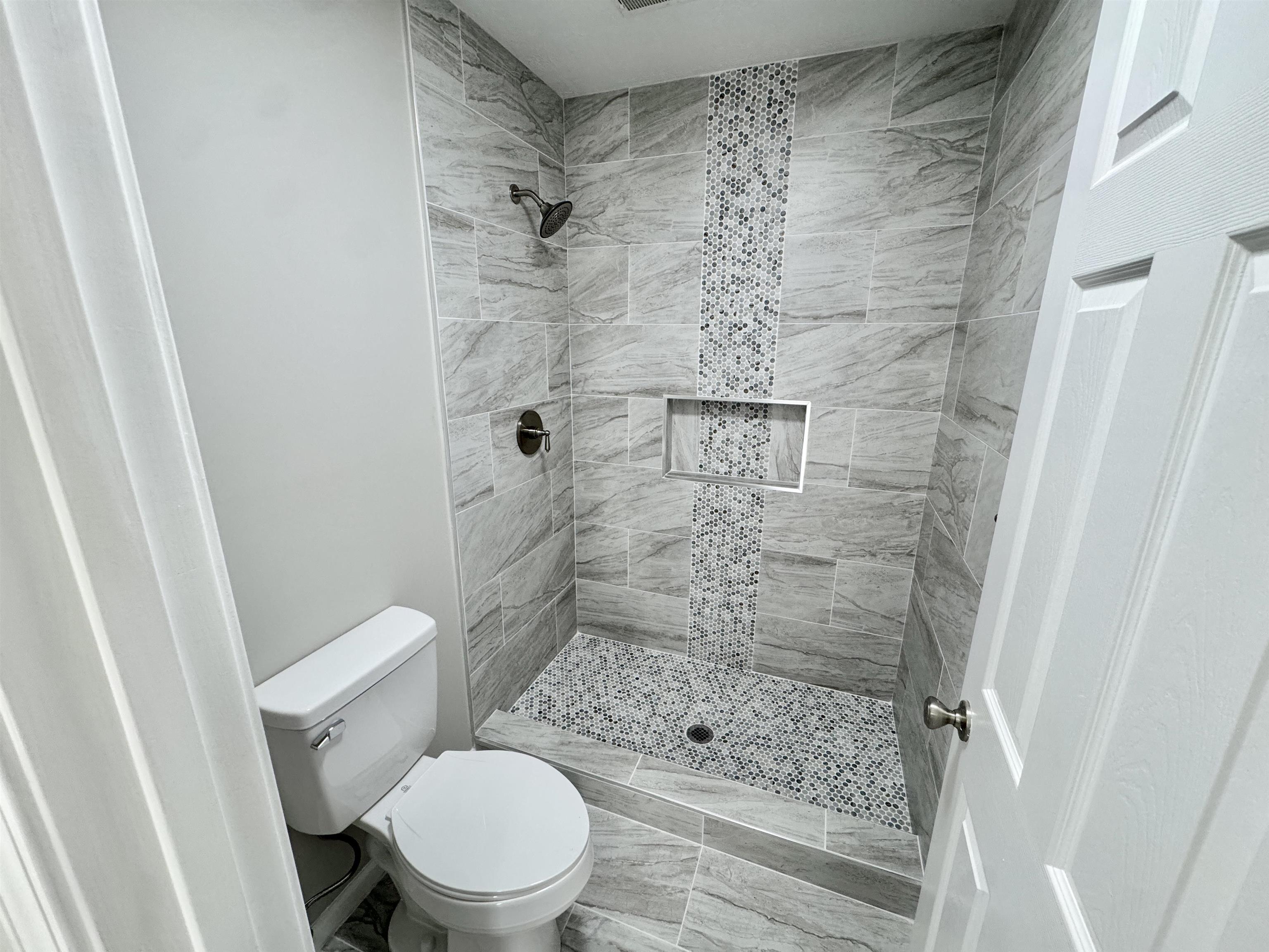 526 Stone Ridge Pinson, TN 38366 - Photo 21 of 39 Full bathroom featuring a tile shower and toilet
