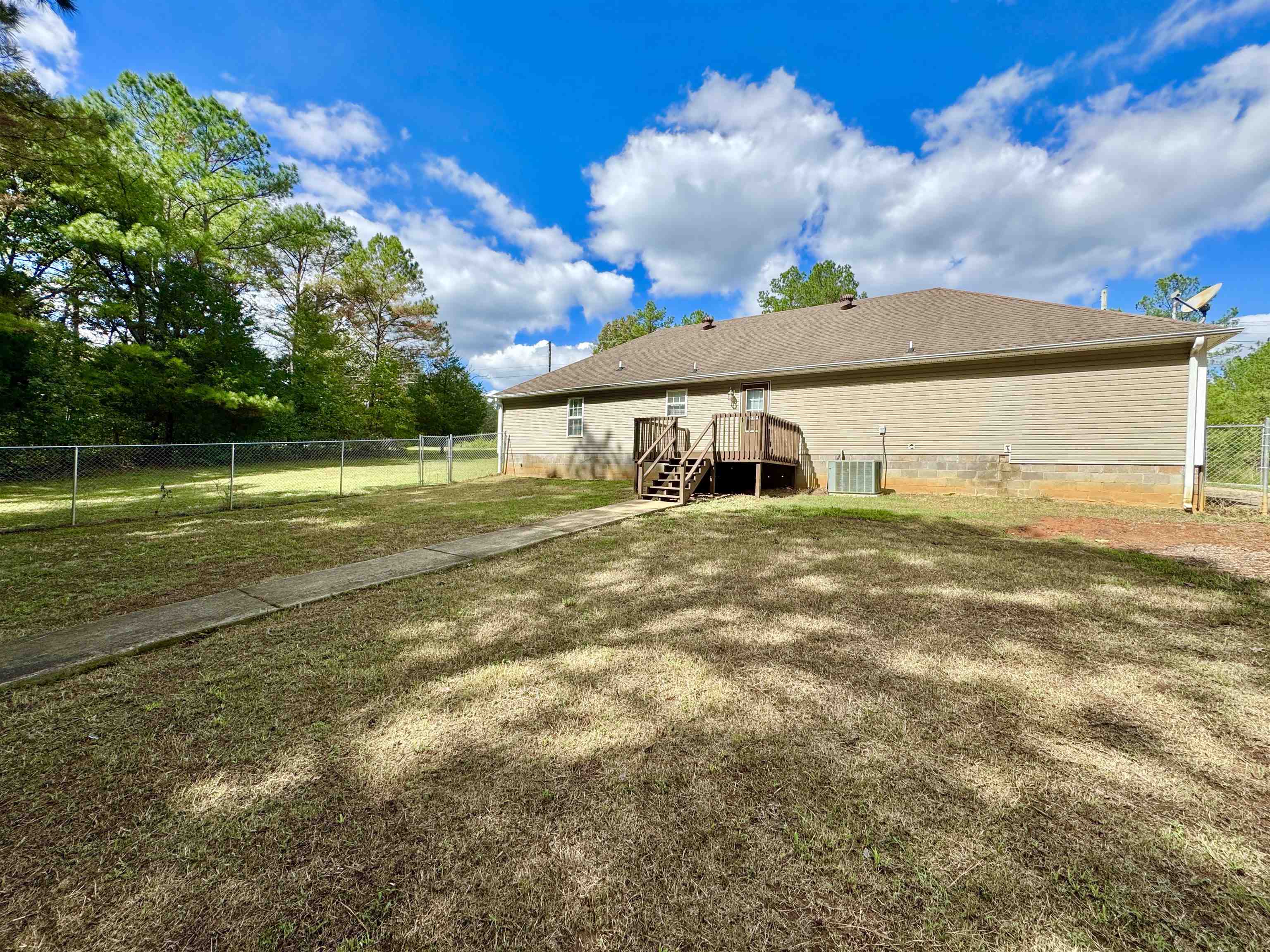 526 Stone Ridge Pinson, TN 38366 - Photo 37 of 39 Rear view of house featuring a fenced backyard, crawl space, a wooden deck, and stairway
