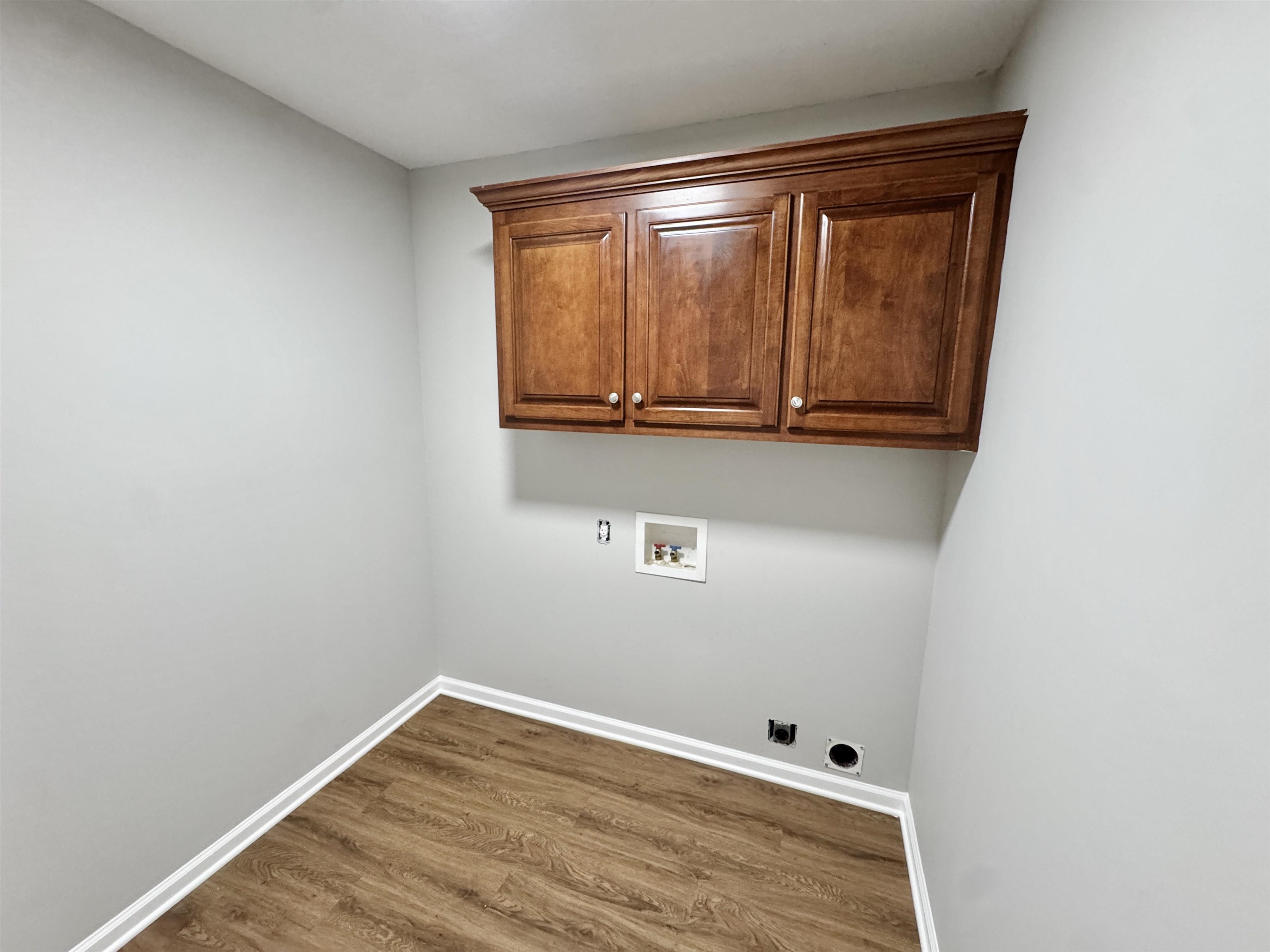 526 Stone Ridge Pinson, TN 38366 - Photo 9 of 39 Washroom with dark wood-style floors, cabinet space, washer hookup, and hookup for an electric dryer