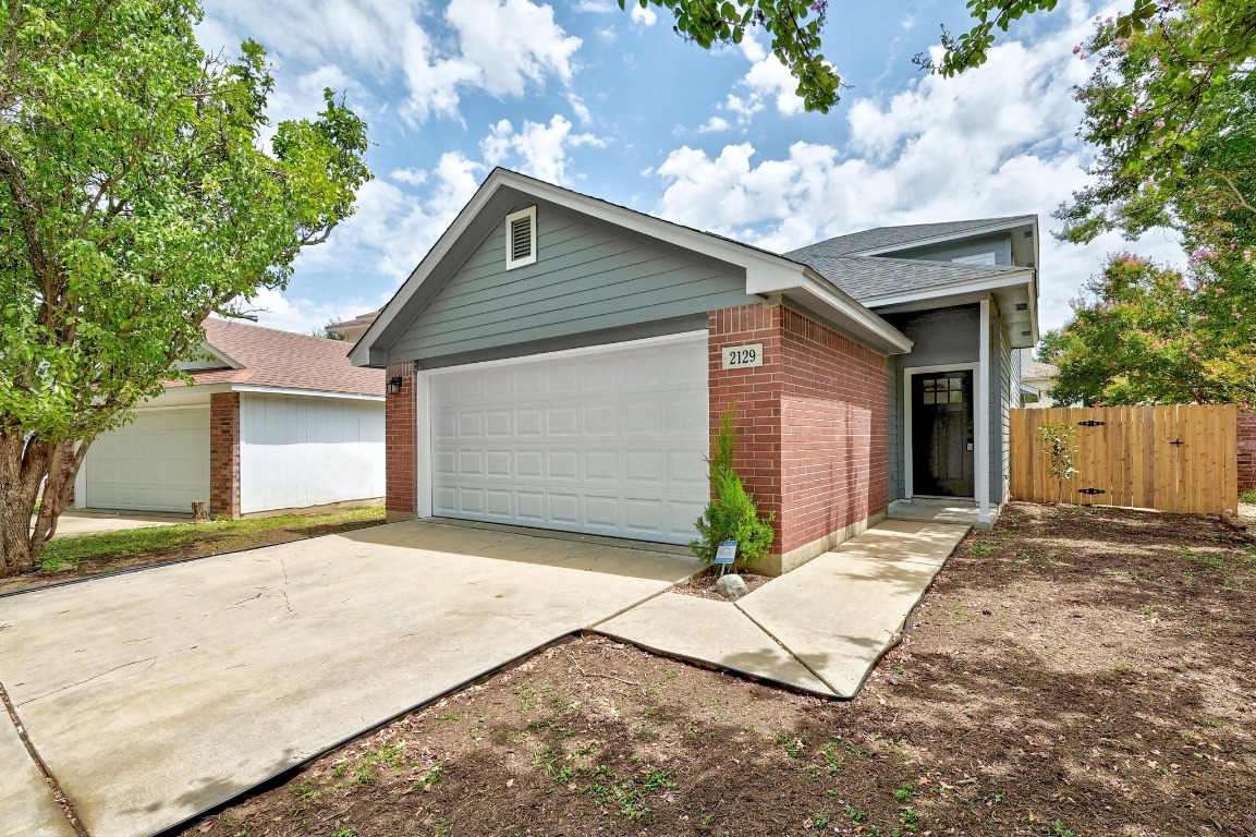 2129 Redwing Way Round Rock, TX 78664 - Photo 2 of 27 a front view of a house with a yard and garage