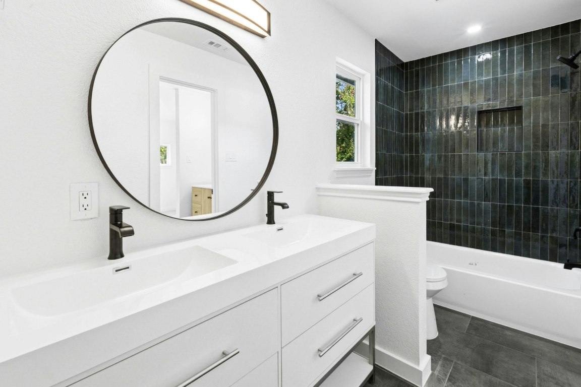 2129 Redwing Way Round Rock, TX 78664 - Photo 21 of 27 a bathroom with a sink a toilet and a mirror