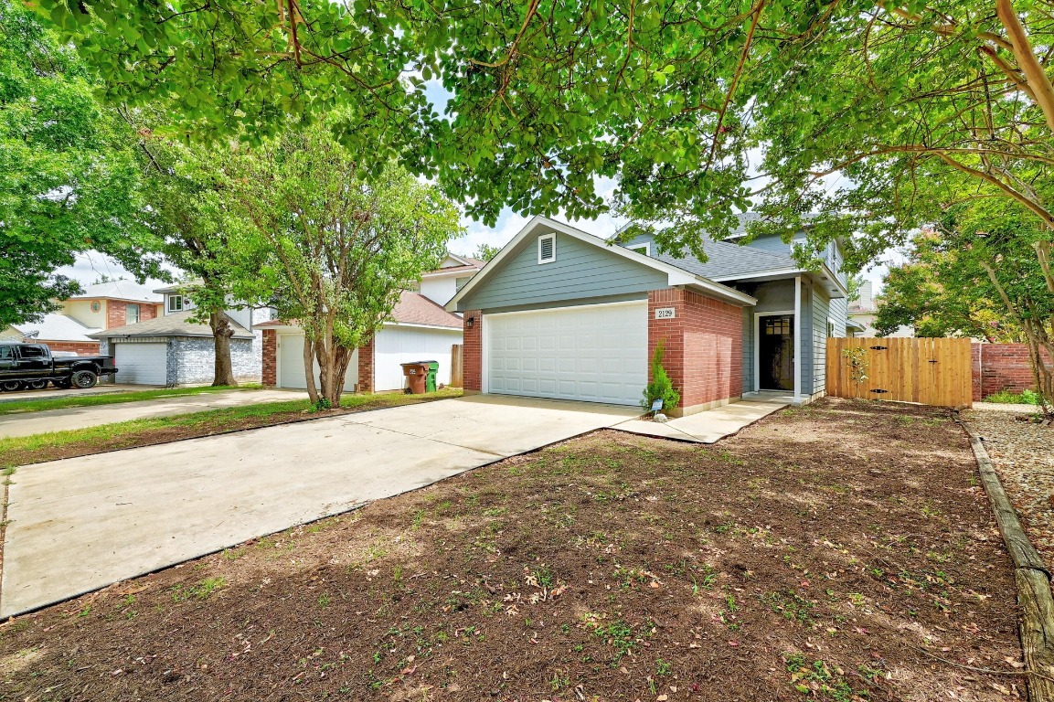 2129 Redwing Way Round Rock, TX 78664 - Photo 4 of 27 a front view of a house with a yard and garage