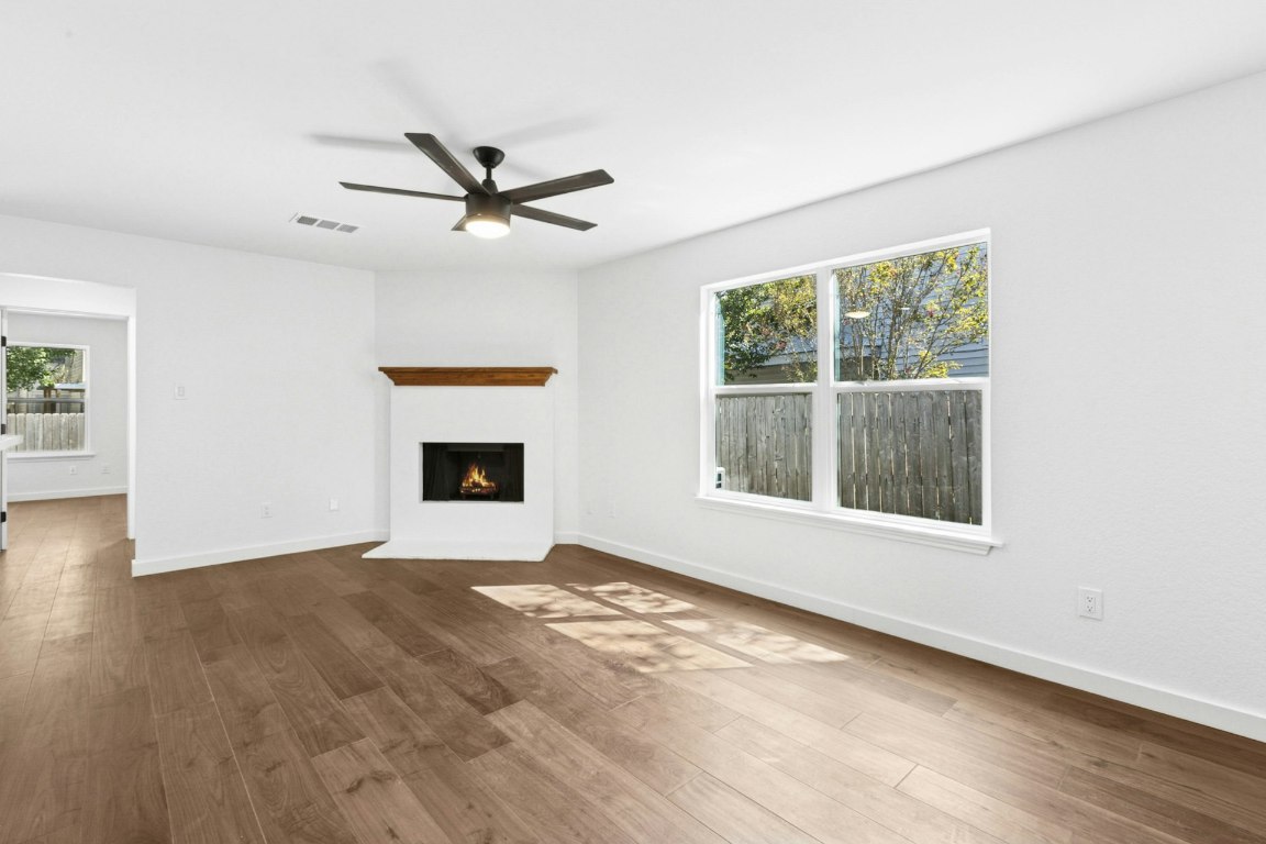 2129 Redwing Way Round Rock, TX 78664 - Photo 6 of 27 an empty room with windows and a ceiling fan