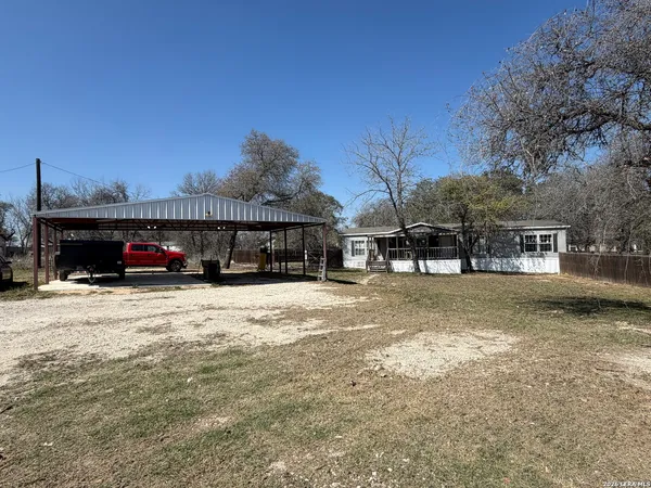 a view of a house with cars park