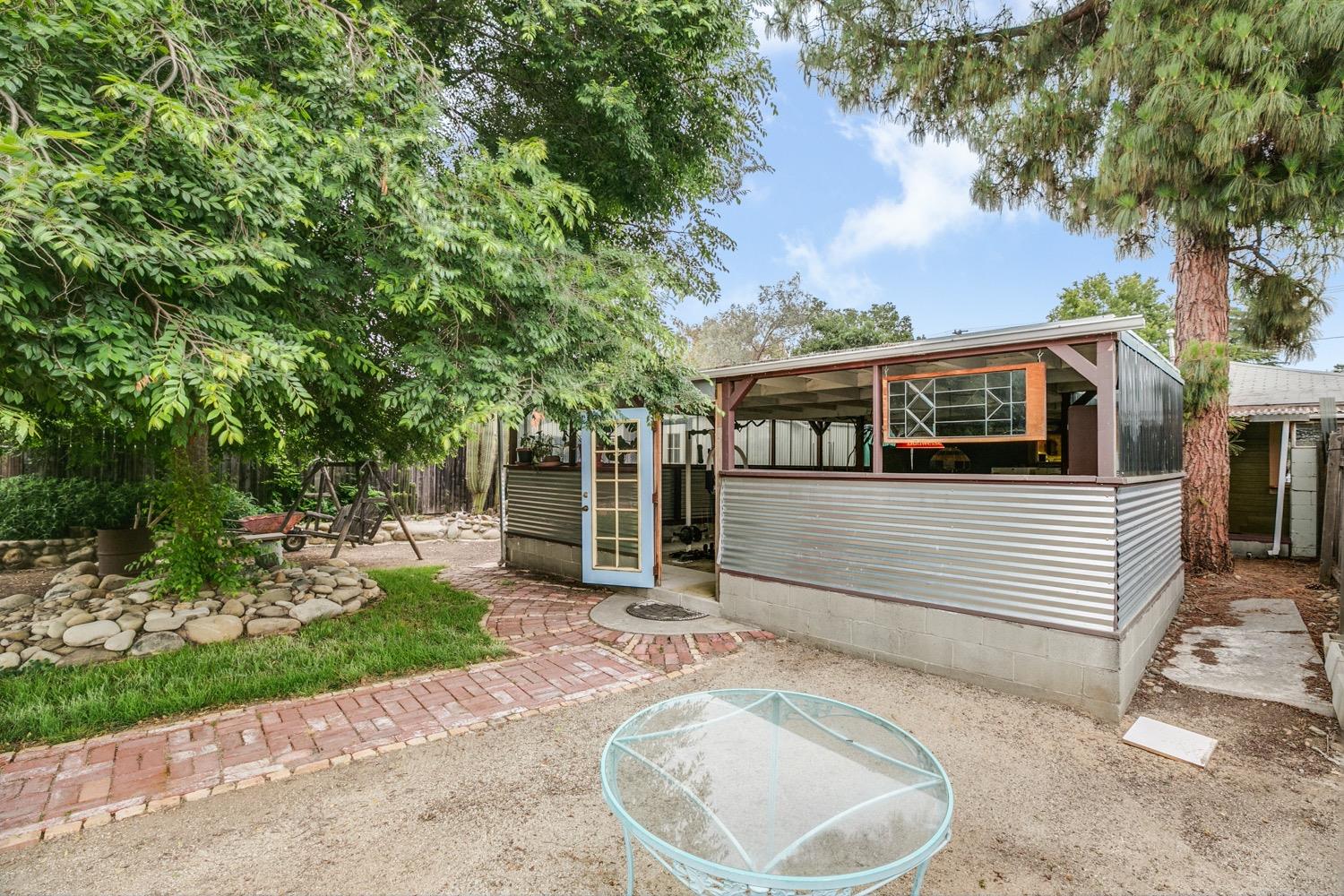 267 Burnham Road Oak View, CA 93022 - Photo 14 of 20 a view of a white house with a small yard plants and large tree
