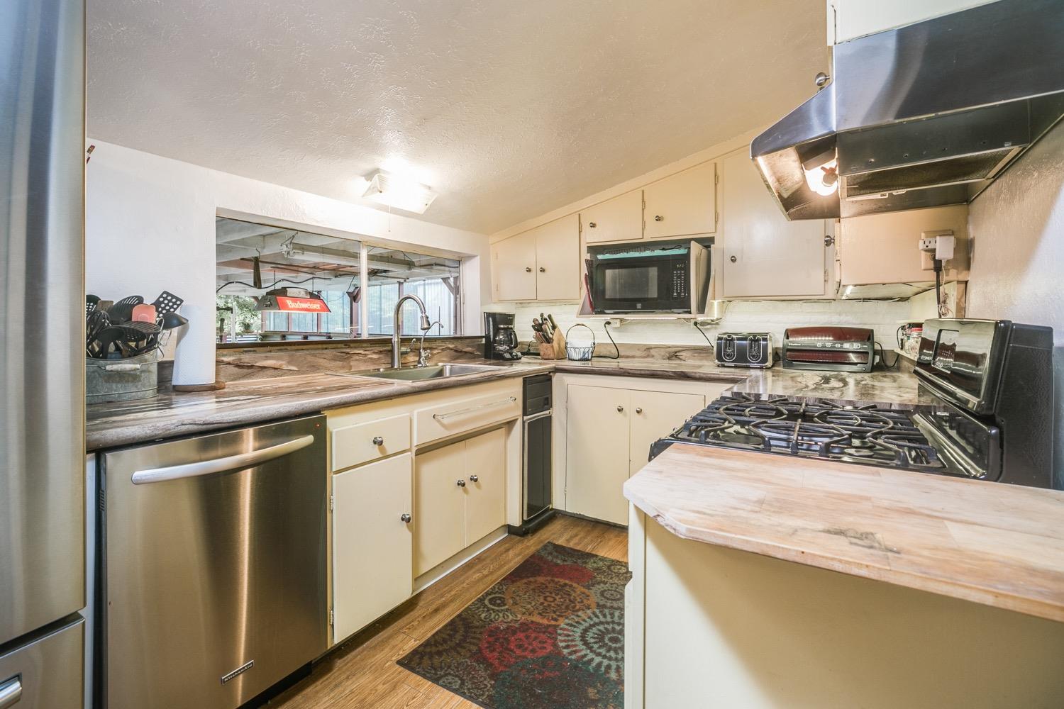 267 Burnham Road Oak View, CA 93022 - Photo 7 of 20 a kitchen with stainless steel appliances granite countertop a sink and cabinets