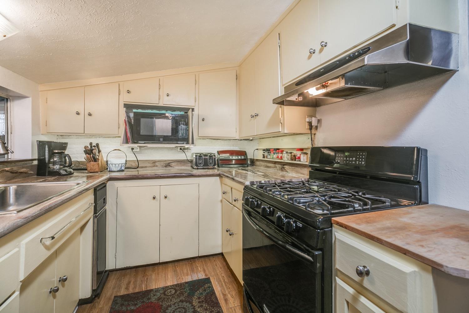 267 Burnham Road Oak View, CA 93022 - Photo 8 of 20 a kitchen with granite countertop stainless steel appliances a sink cabinets and a window