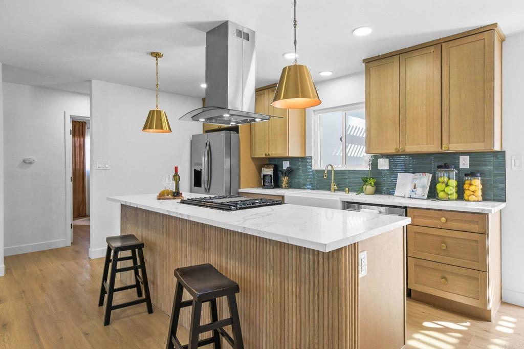 463 Parkbrook Street Spring Valley, CA 91977 - Photo 16 of 37 a kitchen with a sink a stove cabinets and wooden floor