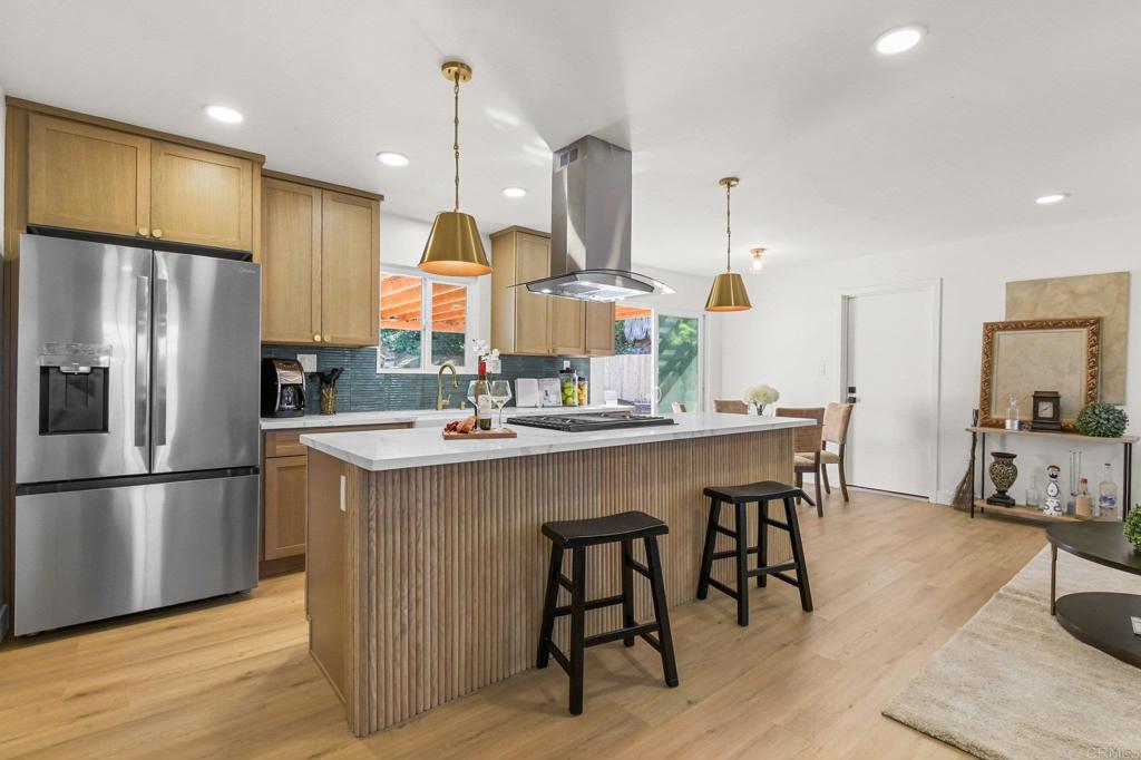 463 Parkbrook Street Spring Valley, CA 91977 - Photo 19 of 37 a kitchen with kitchen island a large counter top space appliances and cabinets