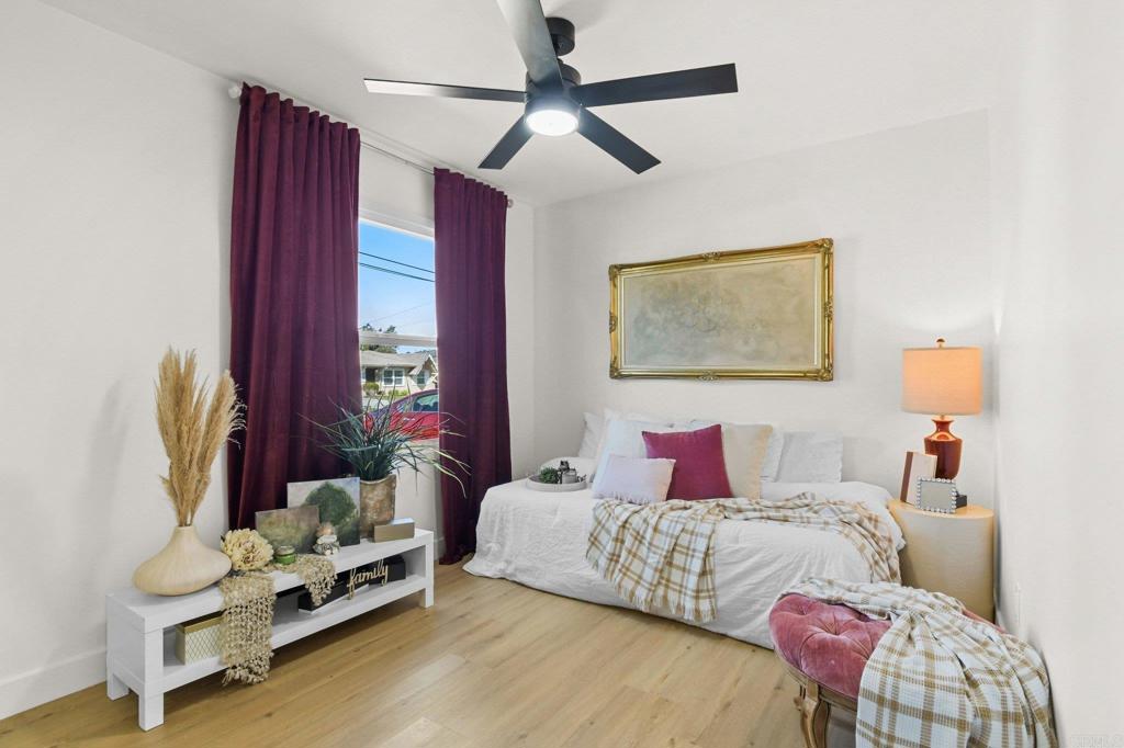 463 Parkbrook Street Spring Valley, CA 91977 - Photo 21 of 37 a bedroom with a bed wooden floor and window