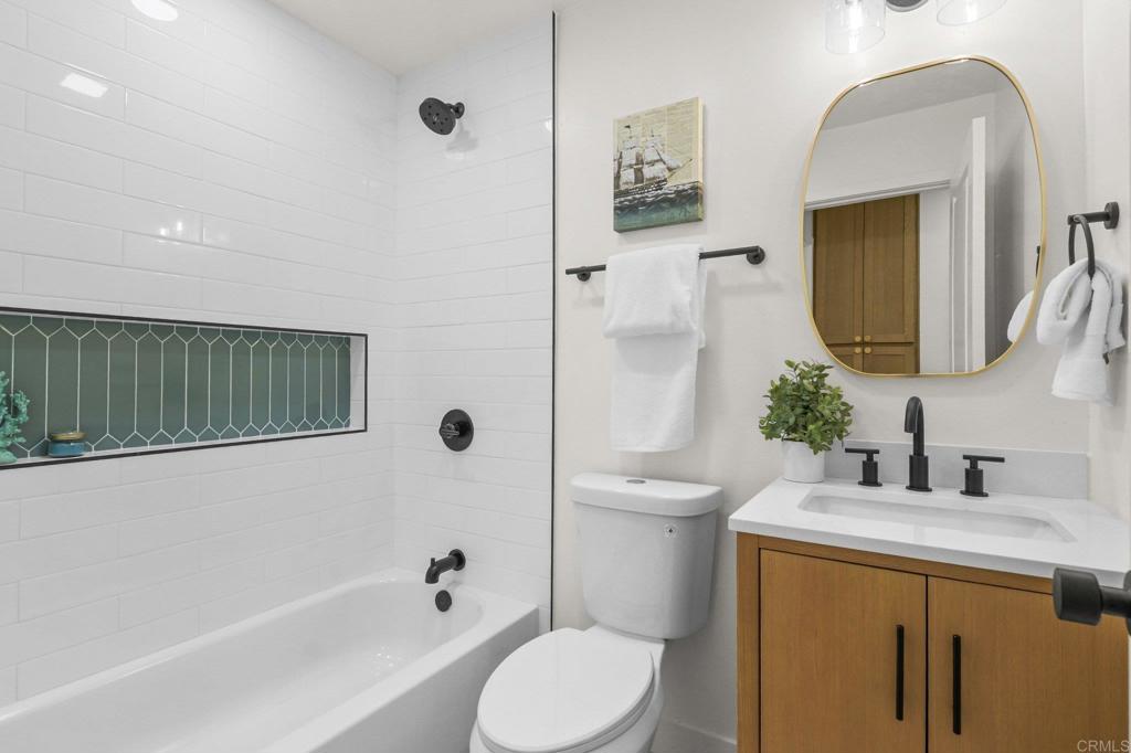 463 Parkbrook Street Spring Valley, CA 91977 - Photo 23 of 37 a bathroom with a granite countertop sink mirror vanity and toilet