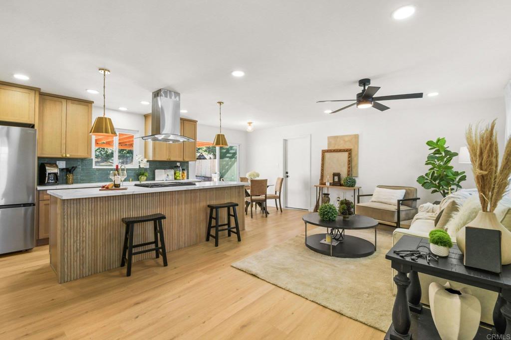 463 Parkbrook Street Spring Valley, CA 91977 - Photo 10 of 37 a living room with furniture a rug kitchen view and a potted plant