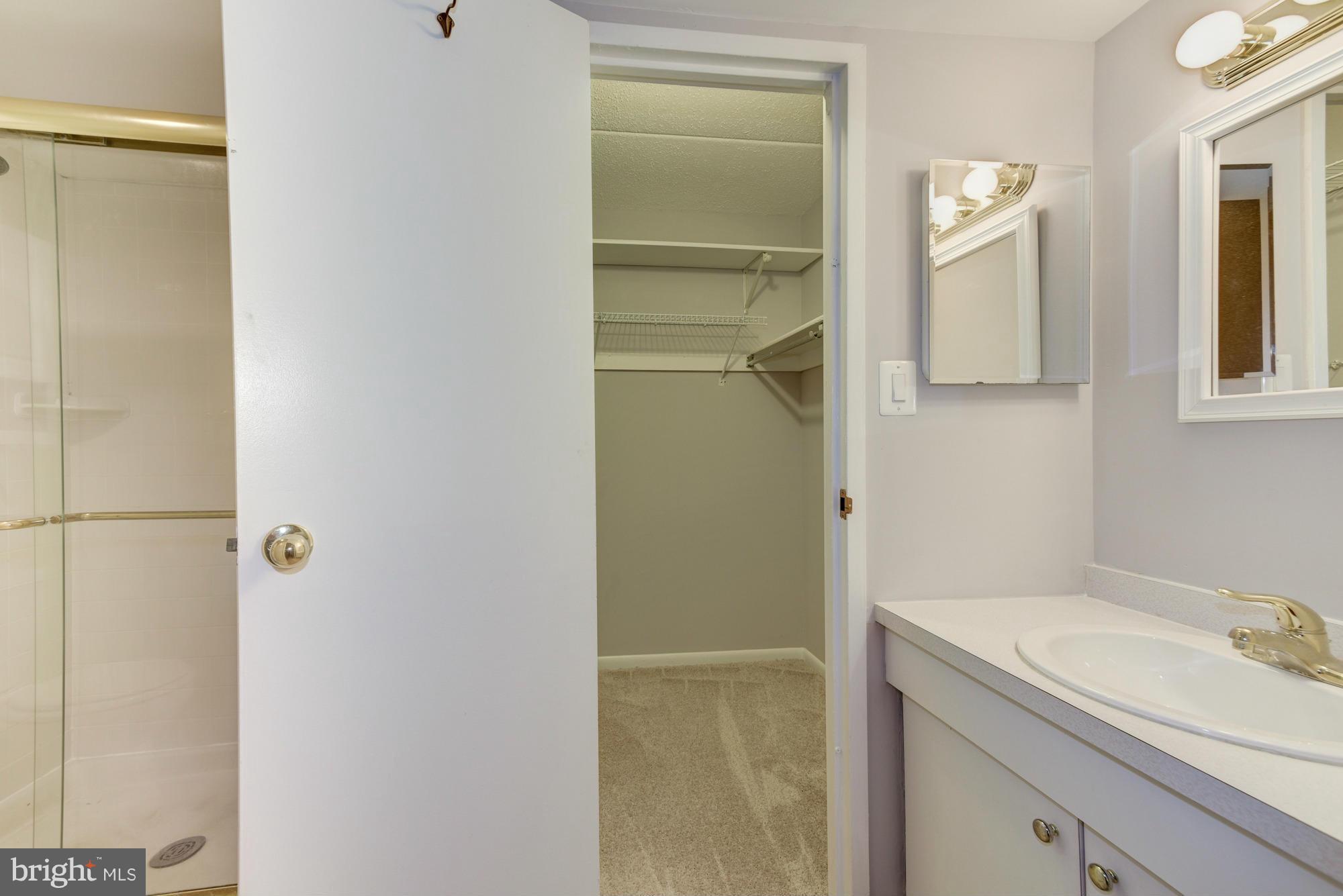11727 Ledura Court, Unit T2 Reston, VA 20191 - Photo 12 of 18 a bathroom with a granite countertop sink and a mirror