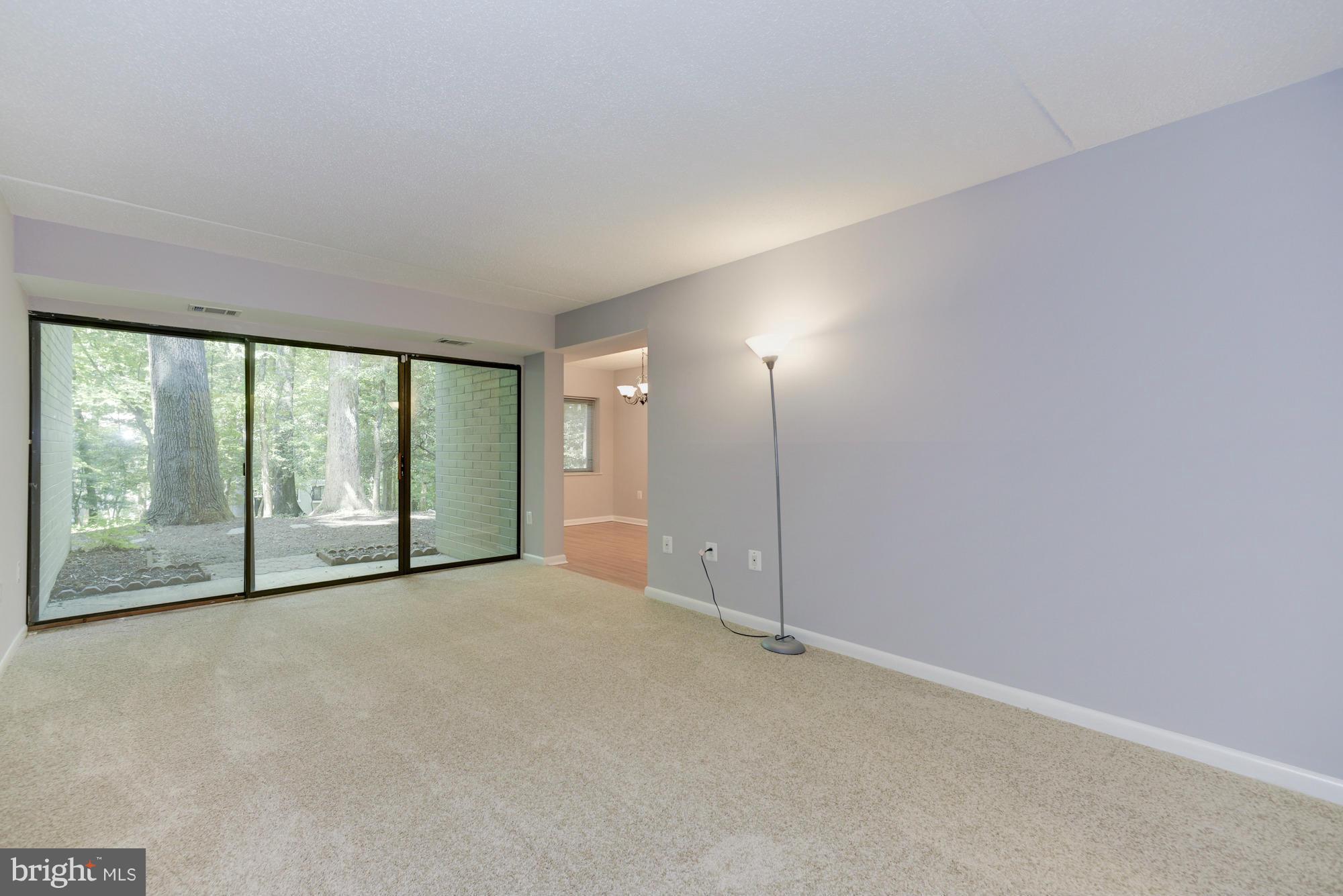 11727 Ledura Court, Unit T2 Reston, VA 20191 - Photo 4 of 18 an empty room with large windows and city view