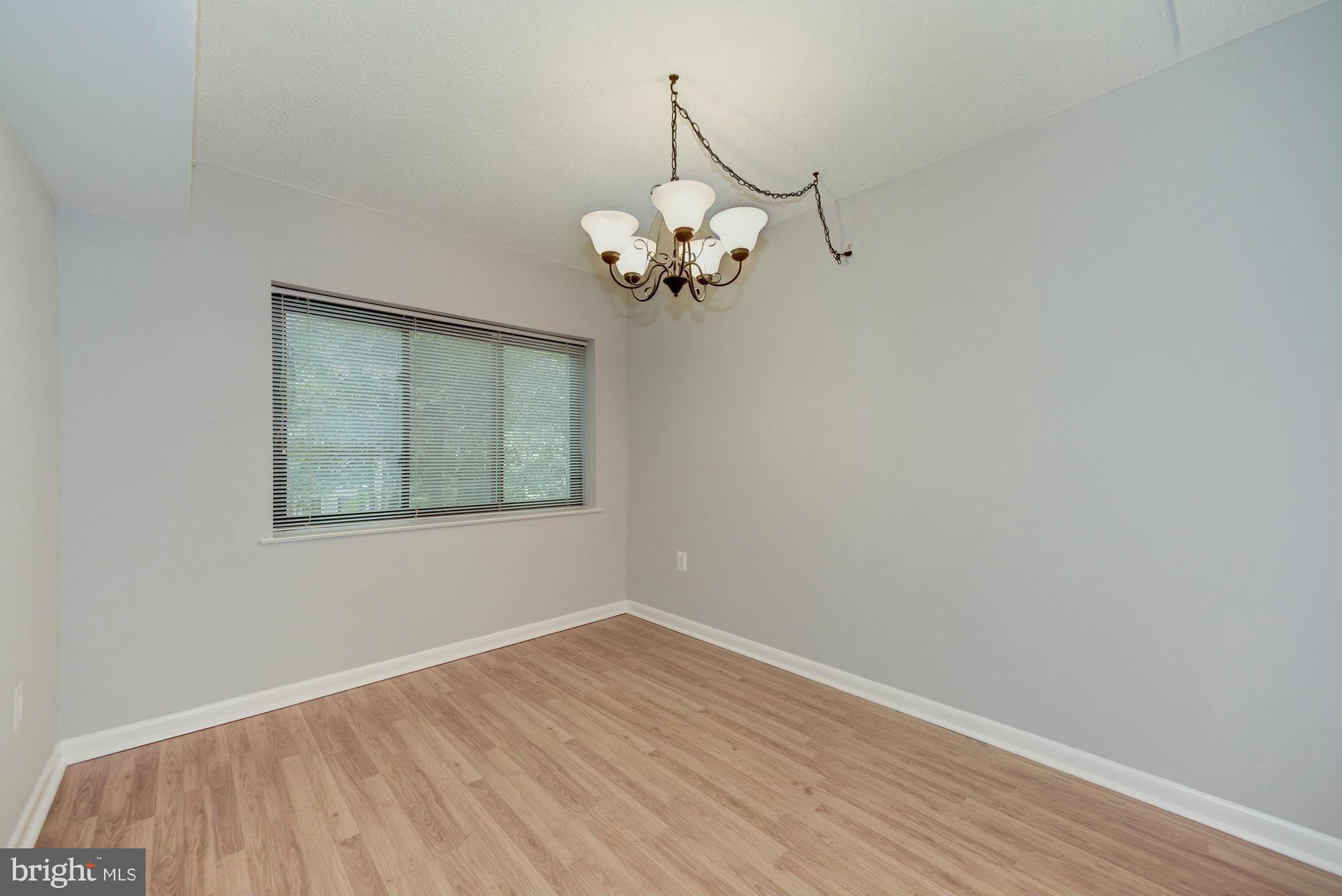 11727 Ledura Court, Unit T2 Reston, VA 20191 - Photo 6 of 18 a view of a room with a large window and wooden floor