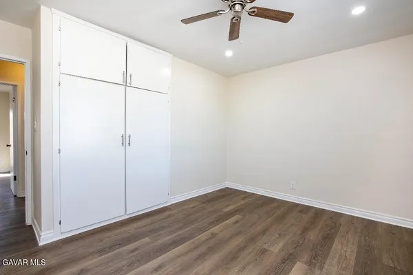 an empty room with a empty space and a ceiling fan