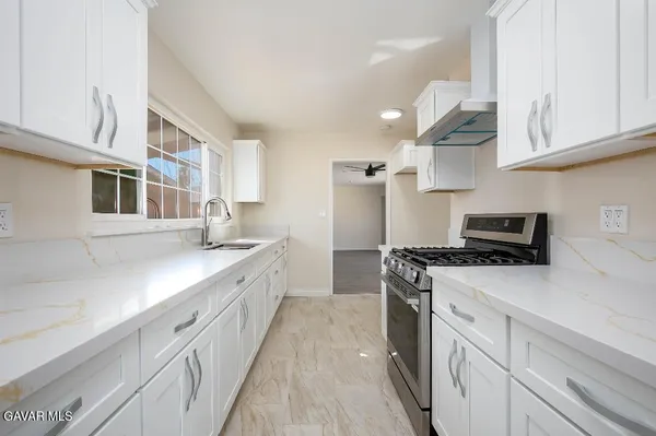 a kitchen with stainless steel appliances granite countertop a stove and a sink