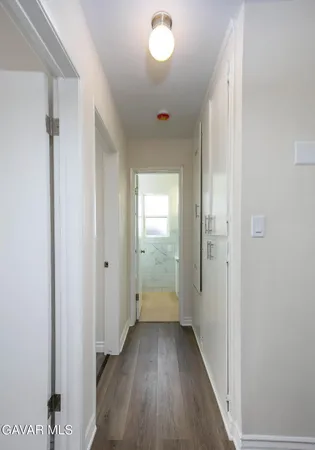 a view of hallway with wooden floor