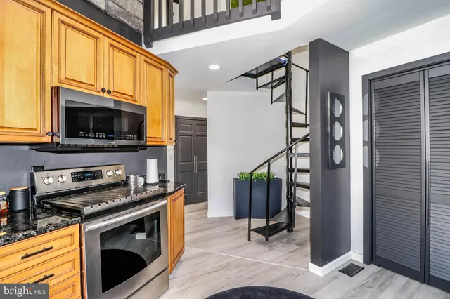 a kitchen with stainless steel appliances a stove a microwave and a refrigerator