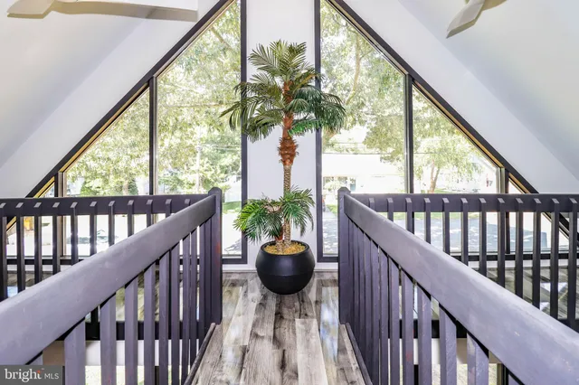 a view of a balcony with chair and potted plants