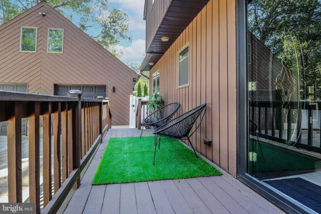 a view of backyard with deck and wooden floor