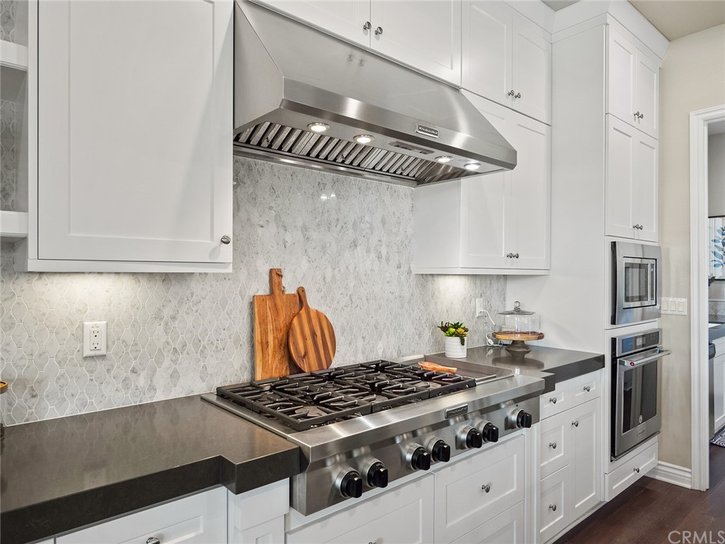 16094 Mariposa Avenue Riverside, CA 92504 - Photo 26 of 72 a kitchen with stainless steel appliances granite countertop a stove and a refrigerator
