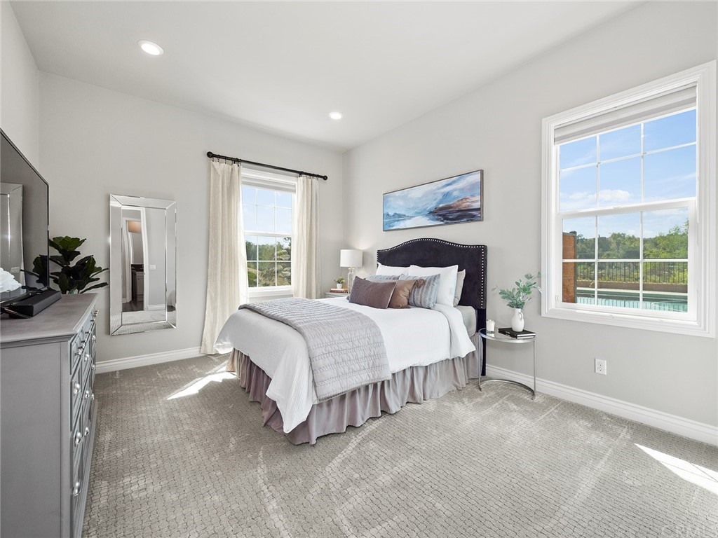 16094 Mariposa Avenue Riverside, CA 92504 - Photo 31 of 72 a bedroom with a large bed and a window