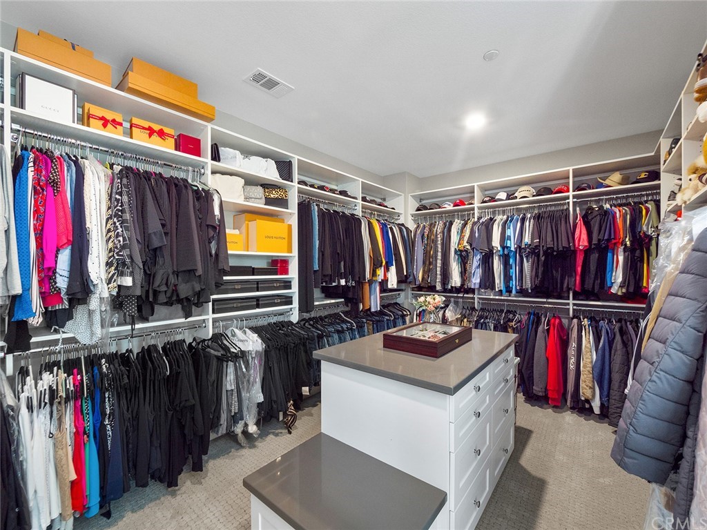 16094 Mariposa Avenue Riverside, CA 92504 - Photo 42 of 72 a view of walk in closet with clothes and shoes