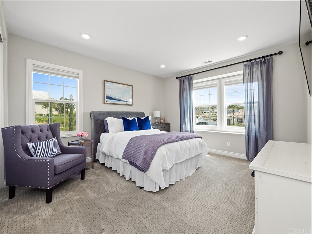 16094 Mariposa Avenue Riverside, CA 92504 - Photo 48 of 72 a spacious bedroom with a bed and a couch