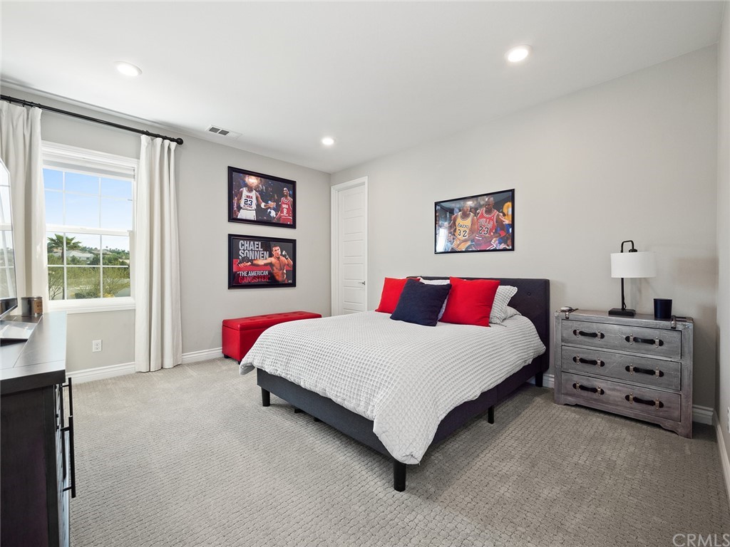 16094 Mariposa Avenue Riverside, CA 92504 - Photo 49 of 72 a spacious bedroom with a bed and a couch