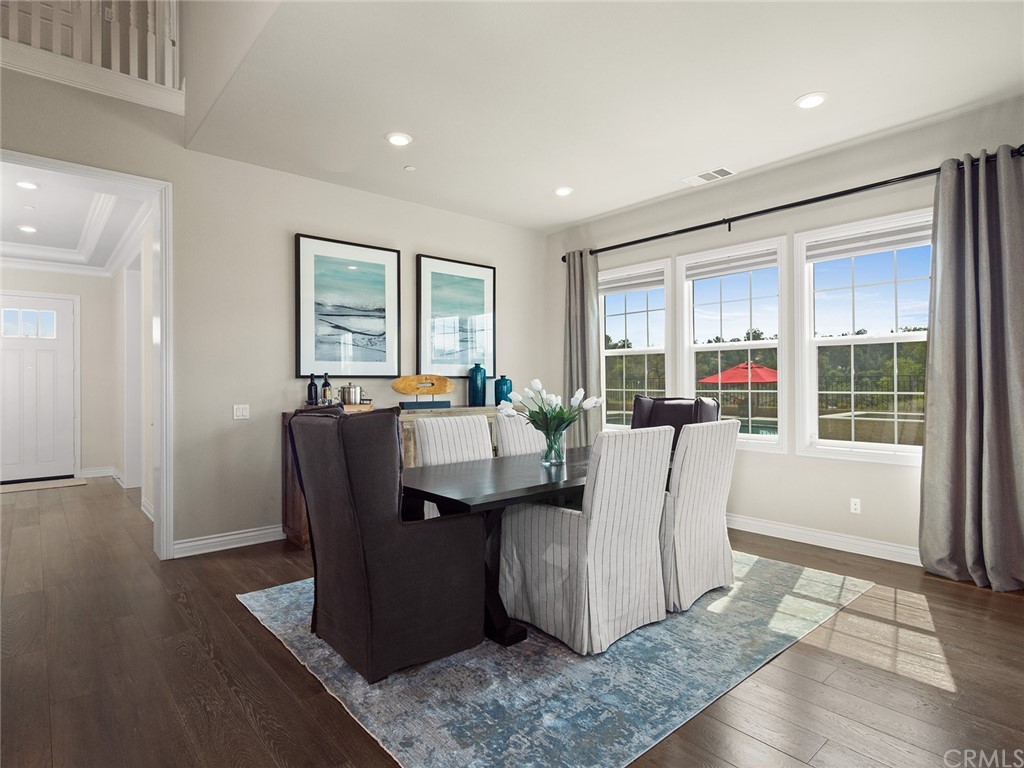 16094 Mariposa Avenue Riverside, CA 92504 - Photo 9 of 72 a living room with couches a coffee table and a large window with wooden floor